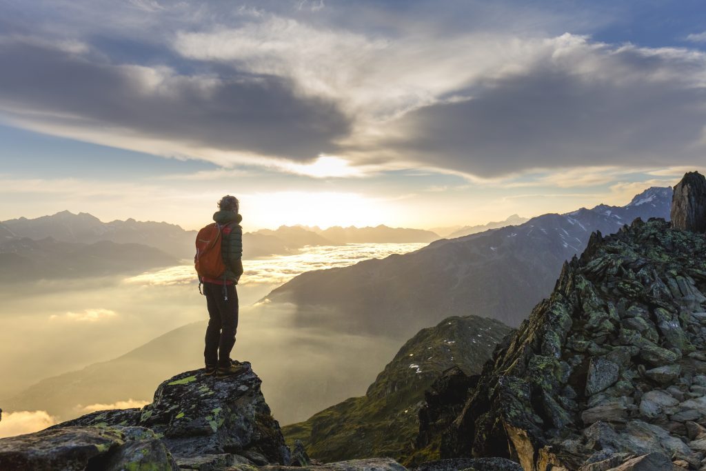 Hiker on mountain enjoying the view as metaphor for Central Bank Digital Currency and its impact on the banking system