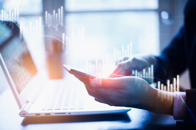 Closeup view of businessman hand touching on smartphone. concept of digital diagram,graph as metaphor for the article "Actively and sustainably managing market data"