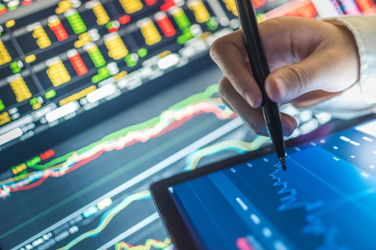 Business analysis stockmarket chart in tablet and computer for investment in crisis as metaphor for "Professionalizing revenue management in banking"