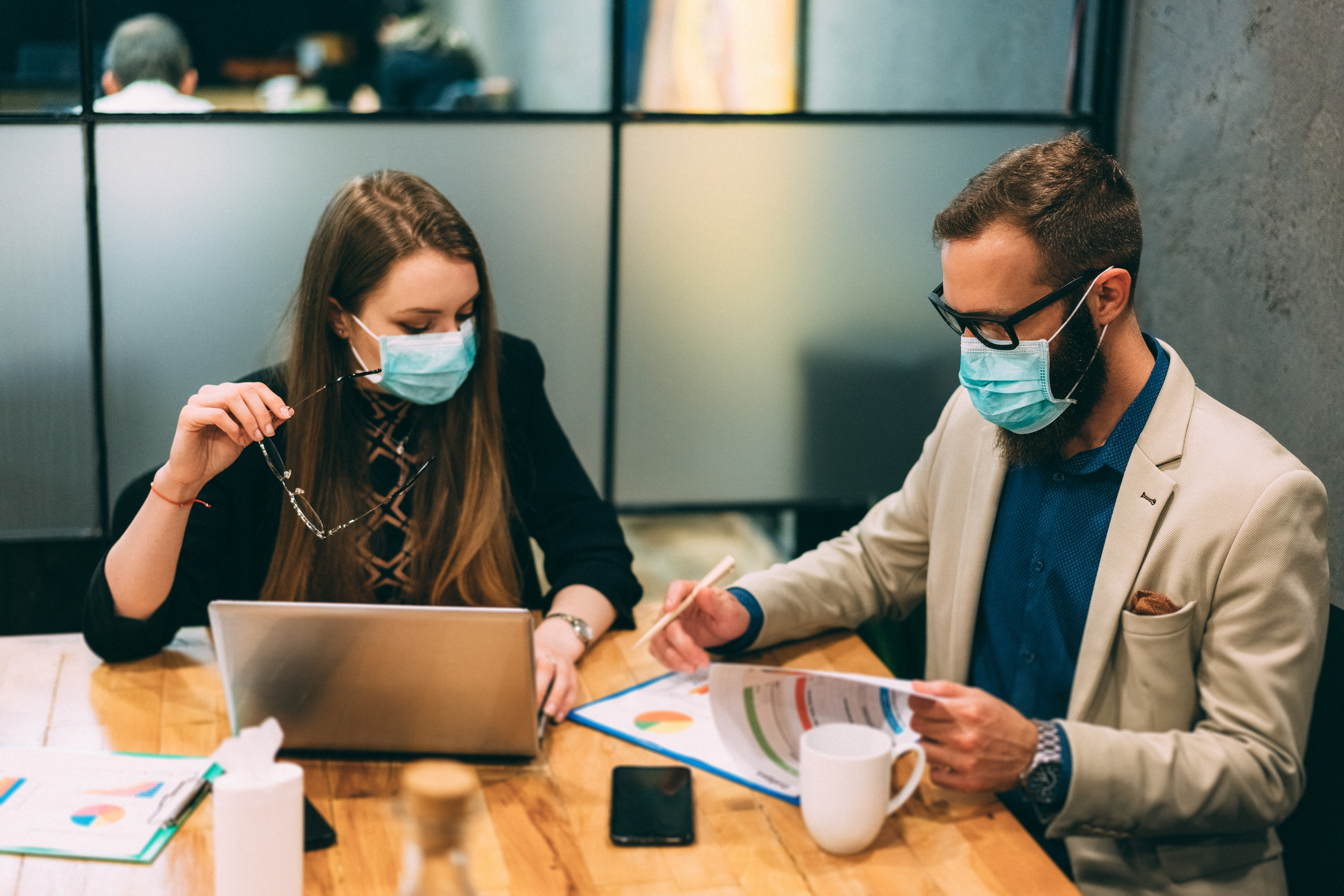 Businesspeople at work during COVID-19 pandemic as metaphor for The COVID-19 impact on banks’ costs