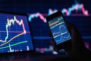 Financial charts on smartphone display as metaphor for electronic stock