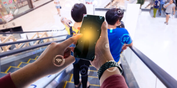 Business person hand holding mobile phone with icons. concept of business and technology communication in the network. as metaphor for "Platform economy—BACK to innovation in banking"